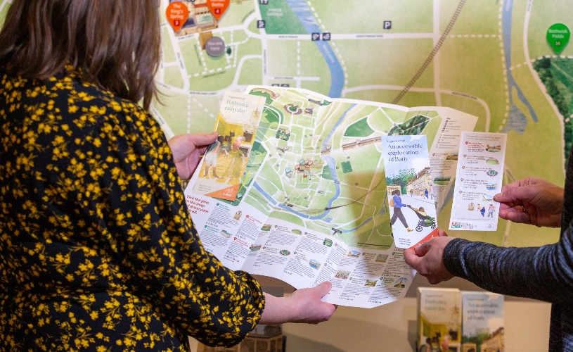 People looking at a map in the Bath World Heritage Centre